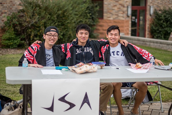 Three Lakeland University students smile at the Student Involvement Fair