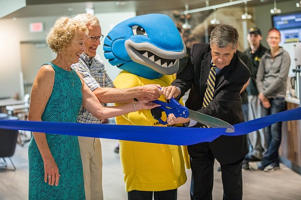 President Black cutting ribbon at opening of campus center with the Younger Family.