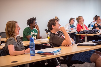 Lakeland University students smile while in class.