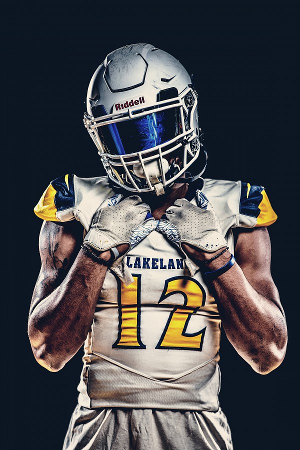 Lakeland football player posing for picture.