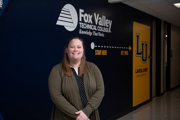 Lakeland University graduate smiling.