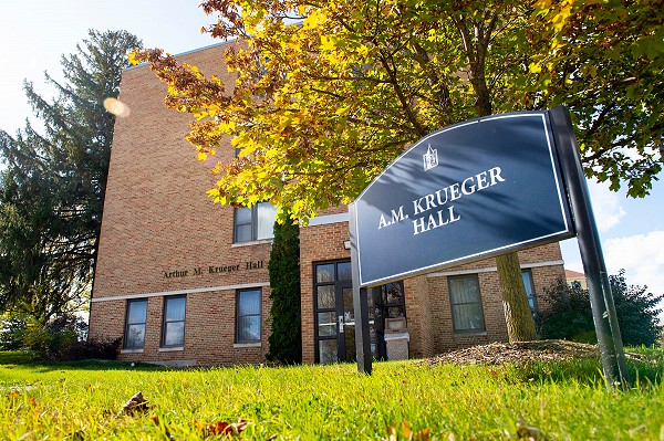 A.M. Krueger Hall exterior and signage.